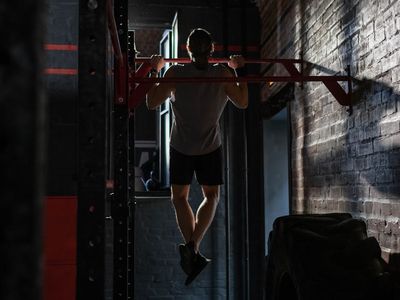 Close-up of a person's hands gripping a pull-up bar.