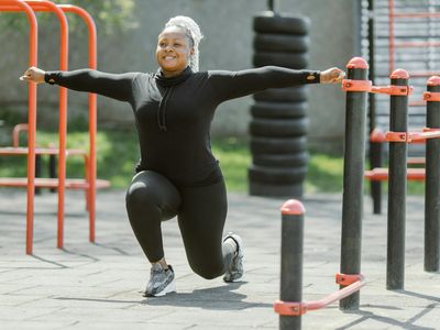 Man performing a bodyweight lunge in an outdoor park setting.